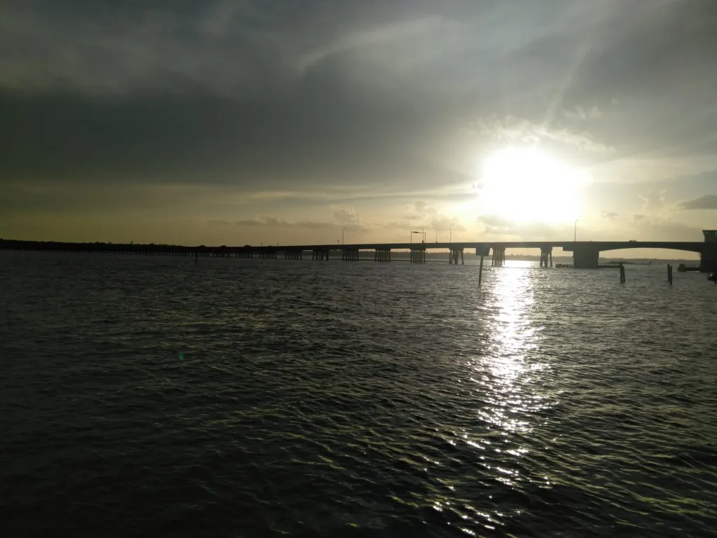 A bridge over the water at sunset