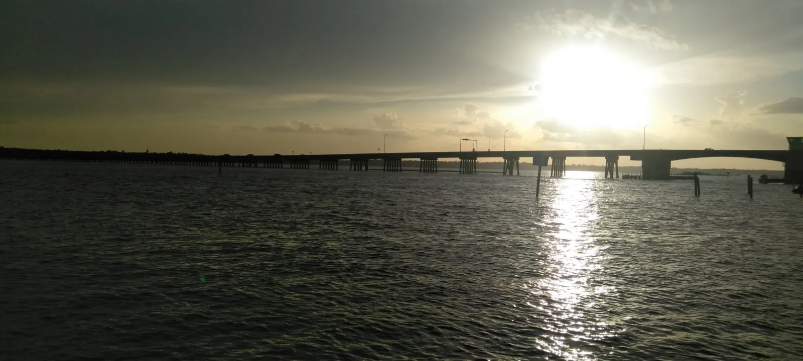 A bridge over the water at sunset
