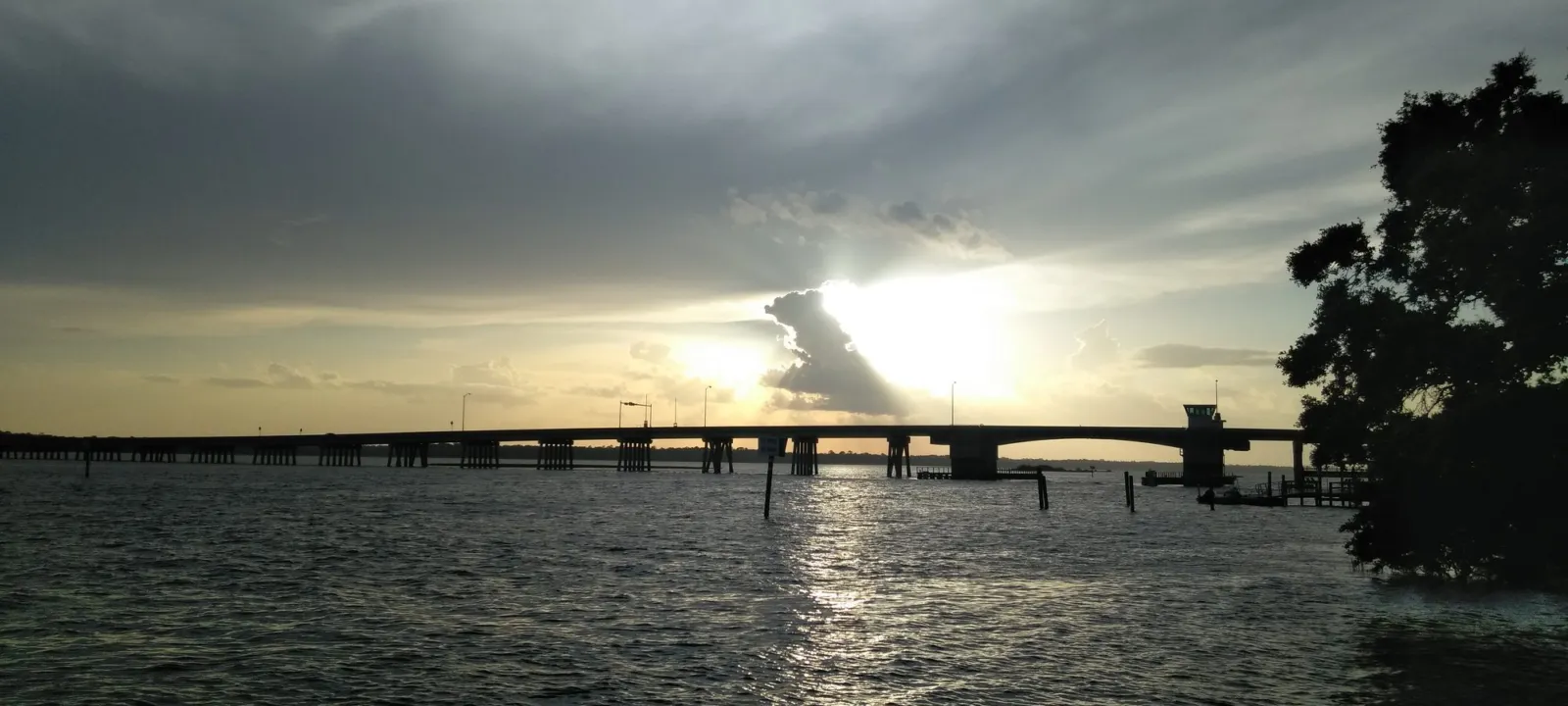 A bridge over the water at sunset