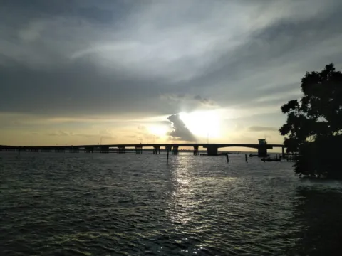 A bridge over the water at sunset
