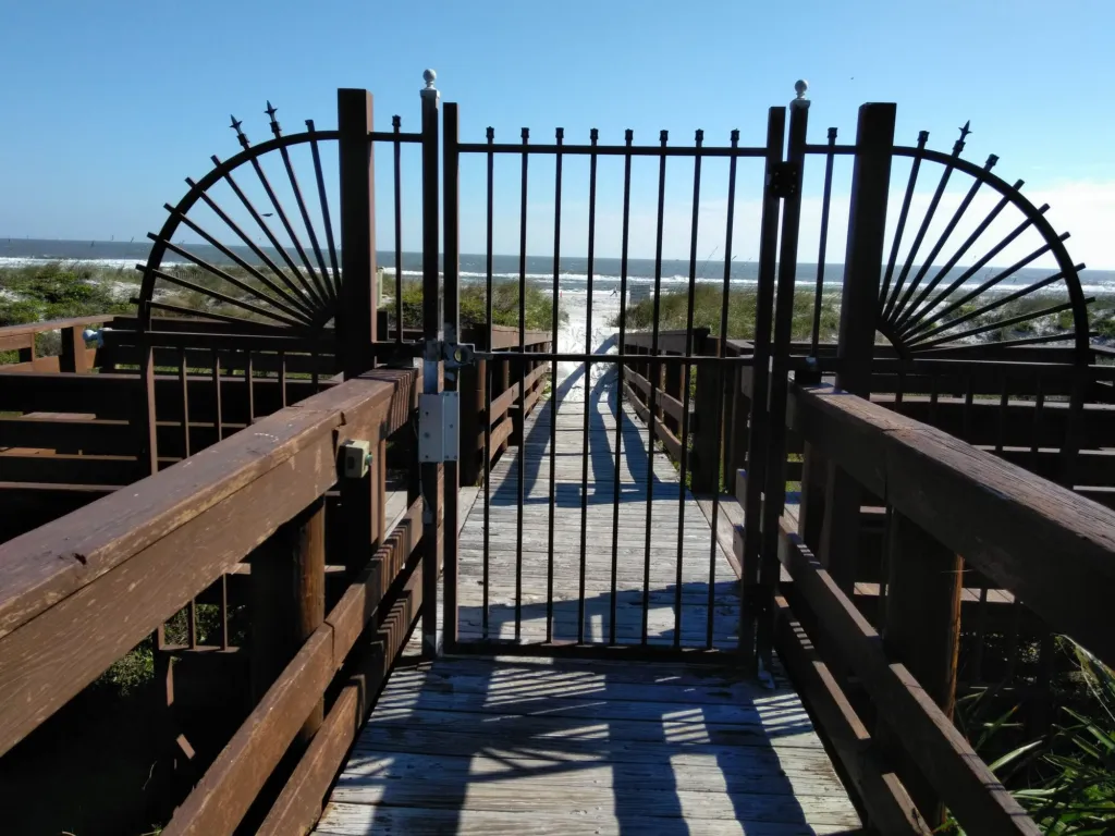 A gated wooden beach walkover through the dunes
