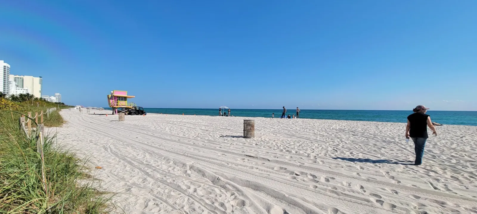 A lifeguard stand on a white sand beach