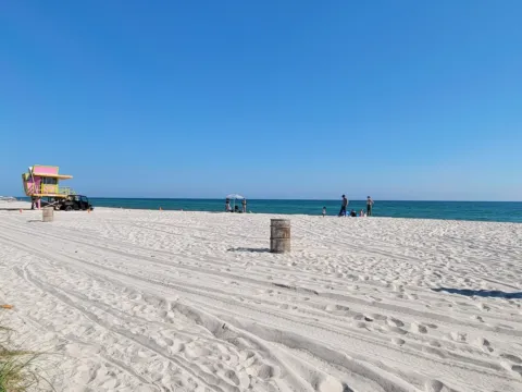 A lifeguard stand on a white sand beach