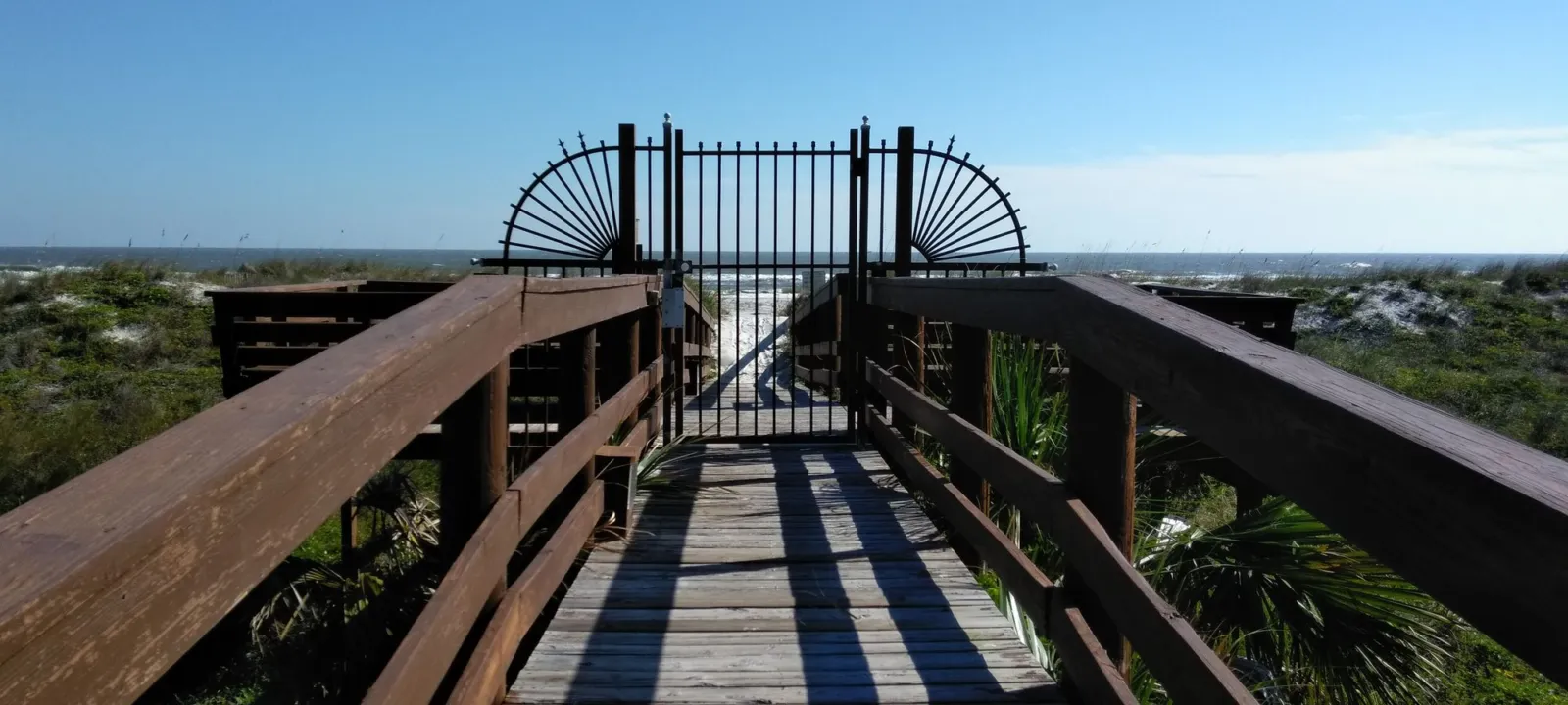 A wooden beach walkover from a rental property to the dunes