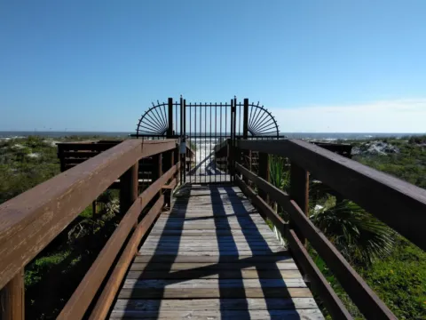 A wooden beach walkover from a rental property to the dunes
