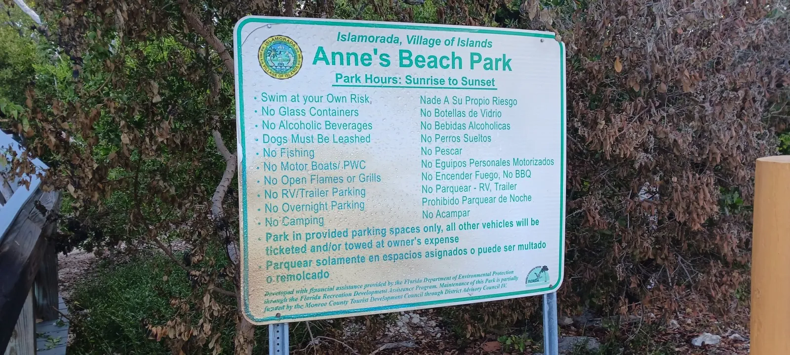The Islamorada village sign at Anne’s Beach Park listing park rules, including Dogs Must Be Leashed and hours of sunrise to sunset.