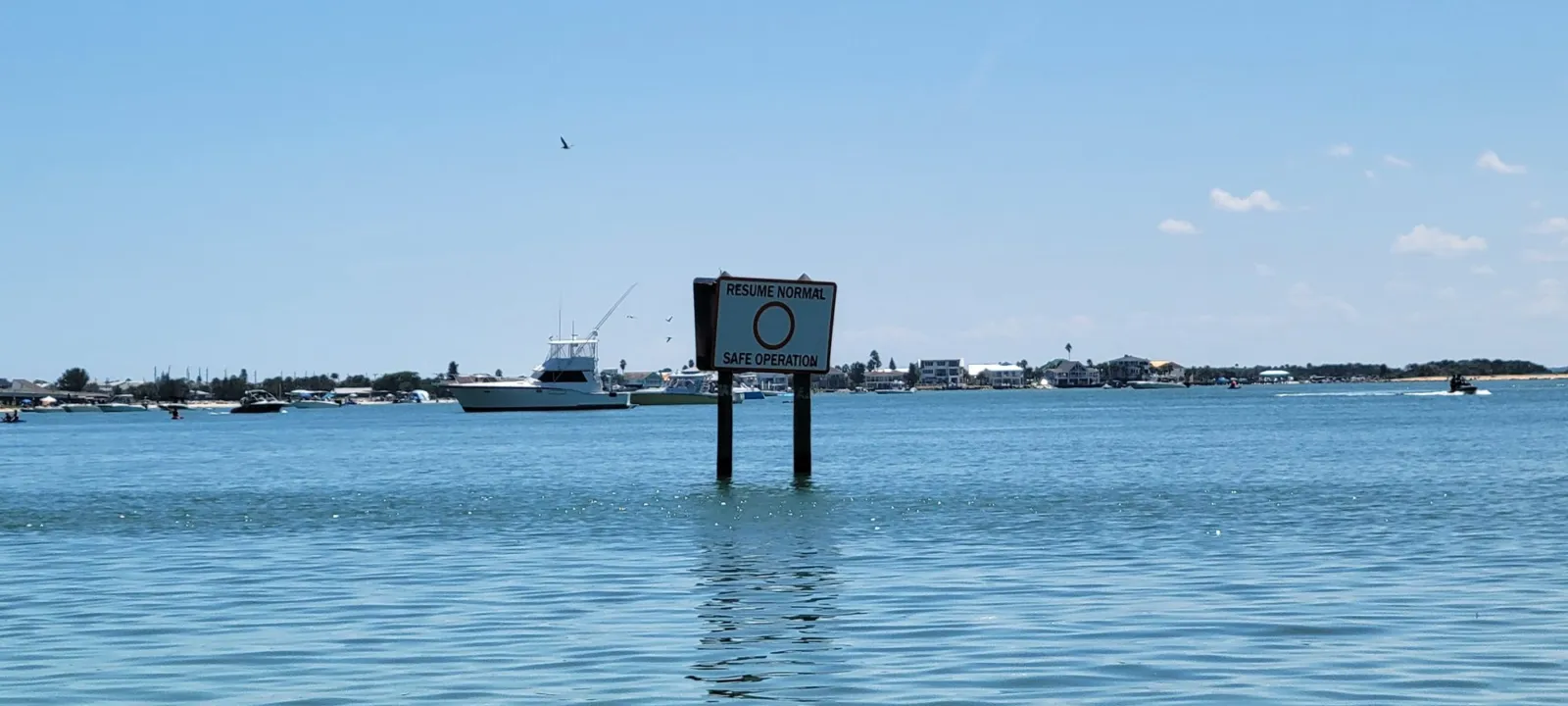 Boats and a channel marker on open water