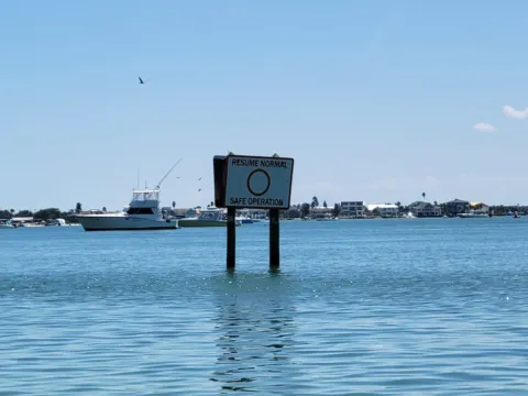 Boats and a channel marker on open water