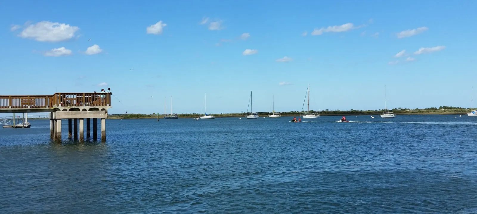 Calm water with docks along the shoreline.