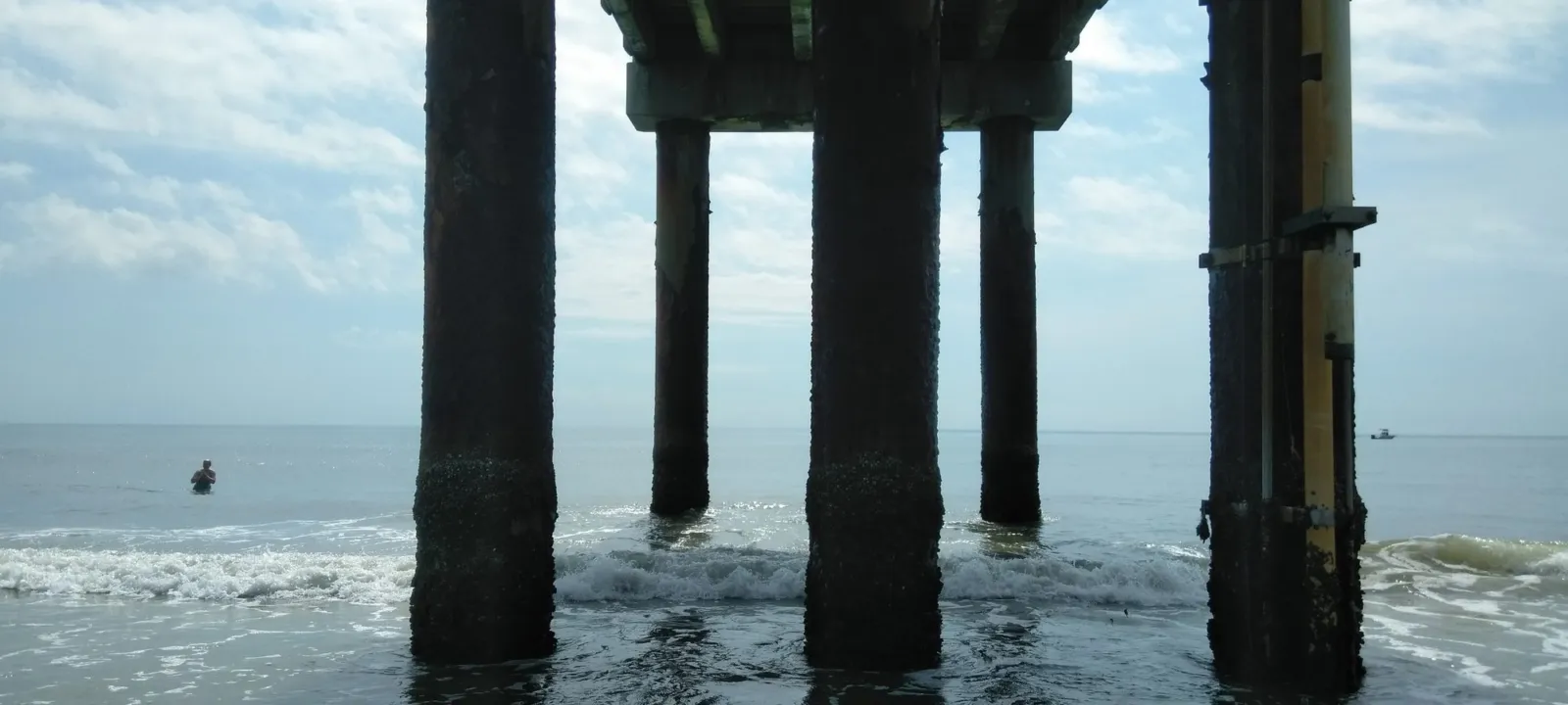Pier pilings standing in the surf