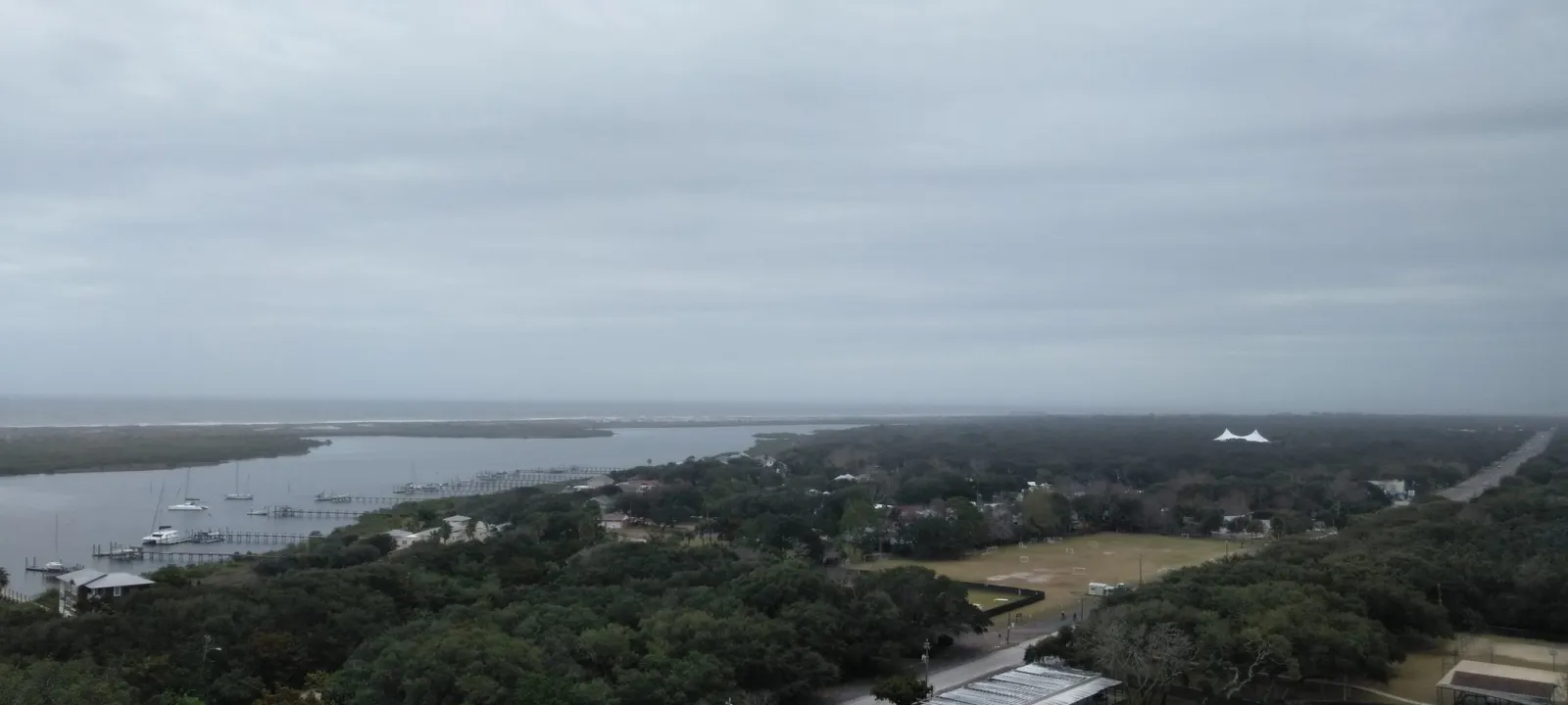 A view from above over trees, marsh and a winding river.