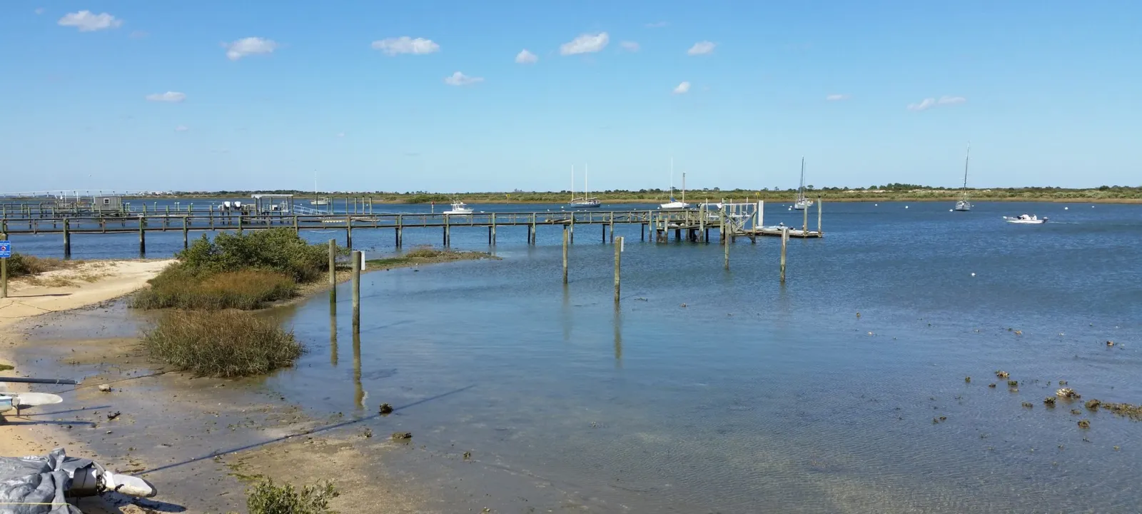 A shallow lagoon with a sandy edge and calm water.