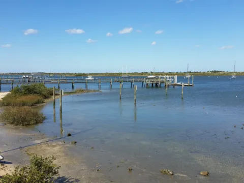 A shallow lagoon with a sandy edge and calm water.